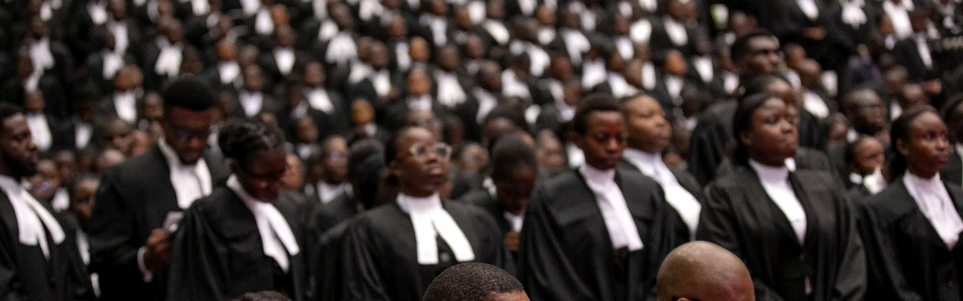 Newly called lawyers in wigs and gowns standing at a call to bar ceremony