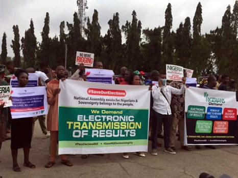 Protesters holding a banner demanding electronic transmission of election results